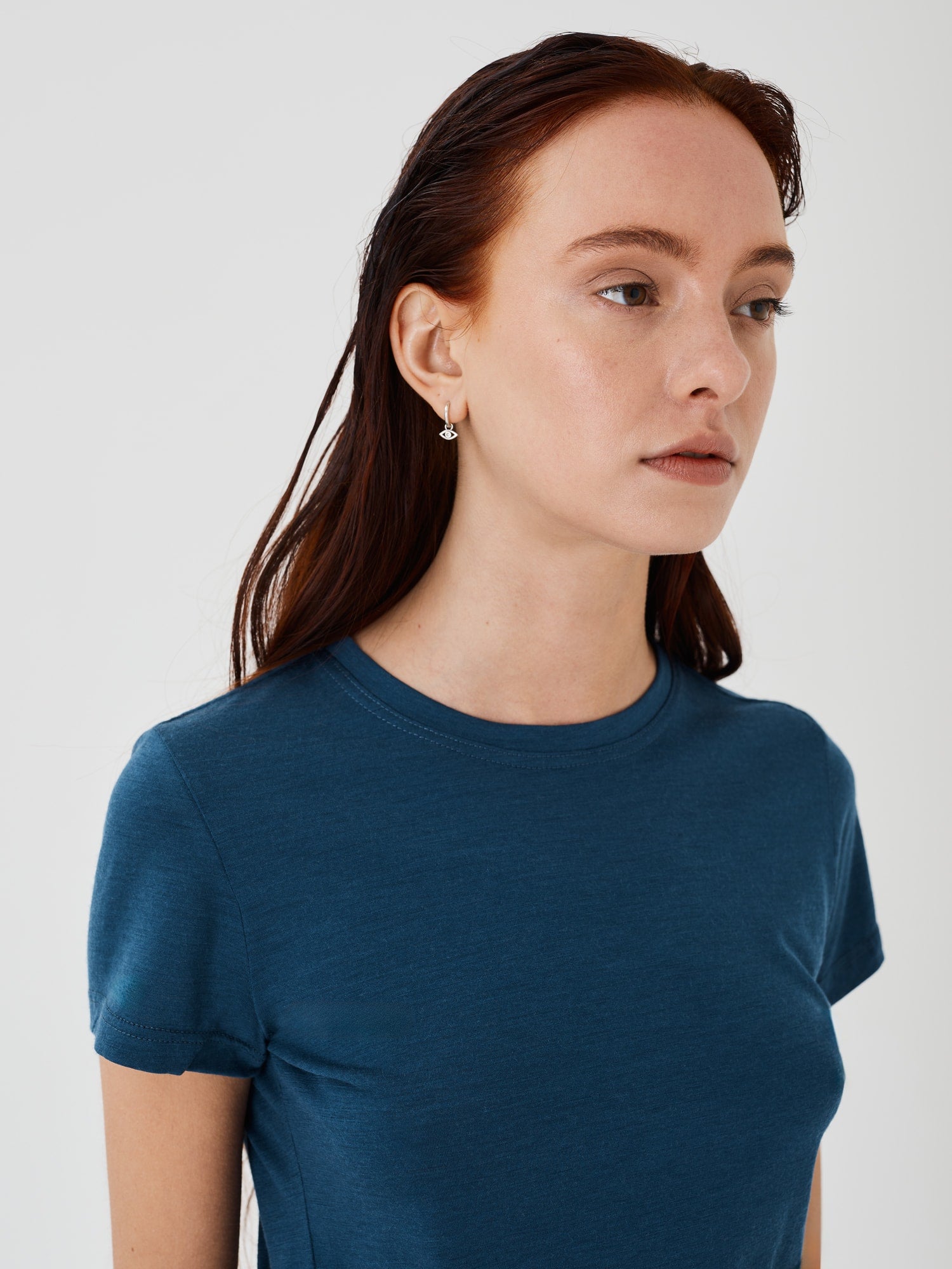 Zoomed-in view of a women's blue merino wool classic T-shirt by Šumska, highlighting the fine fabric texture and stitching details.