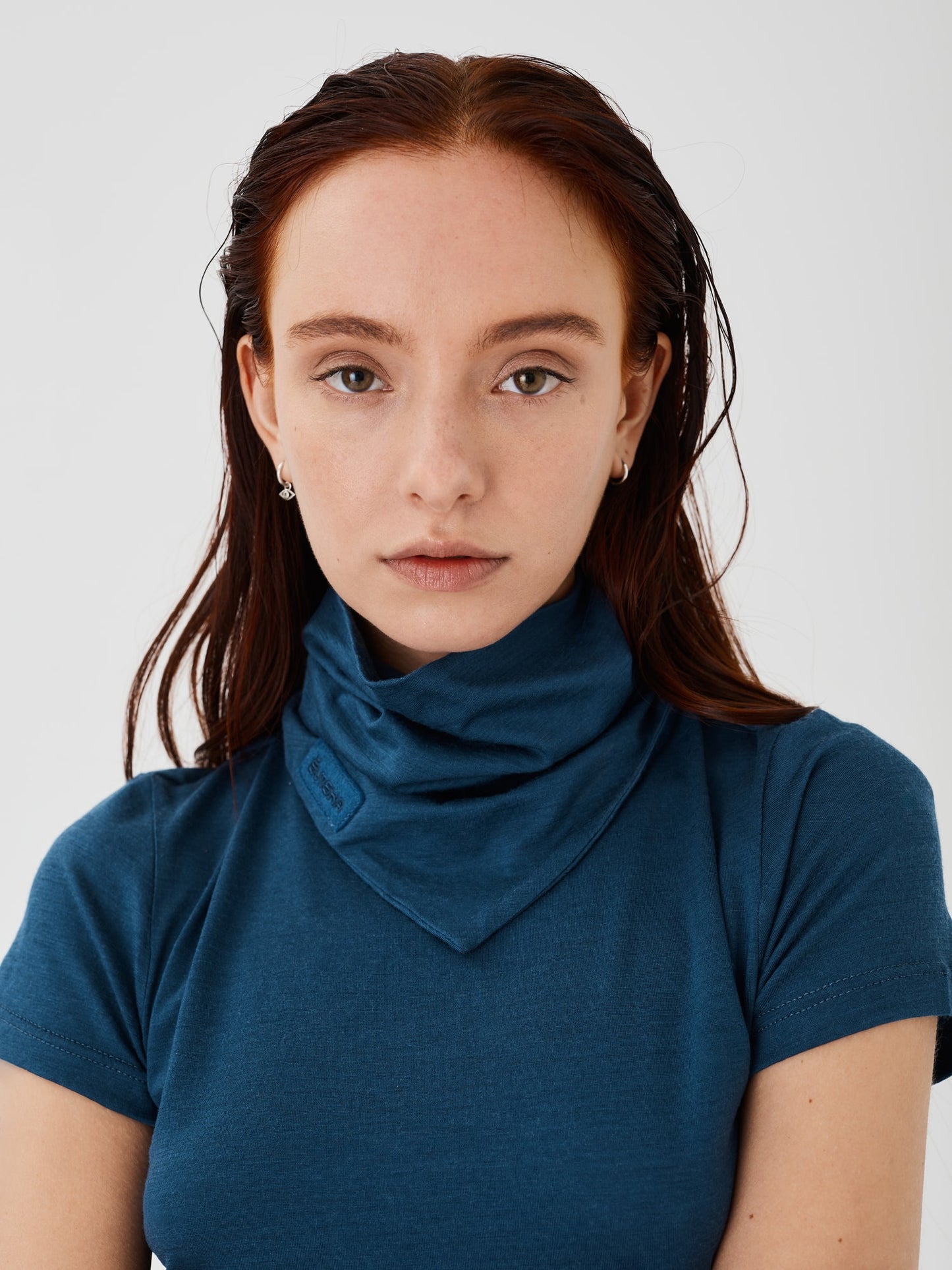 Zoomed-in view of a blue merino wool double-layered neck snood by Šumska, paired with a blue merino wool classic T-shirt, highlighting the soft texture and detailed stitching of the fabric.