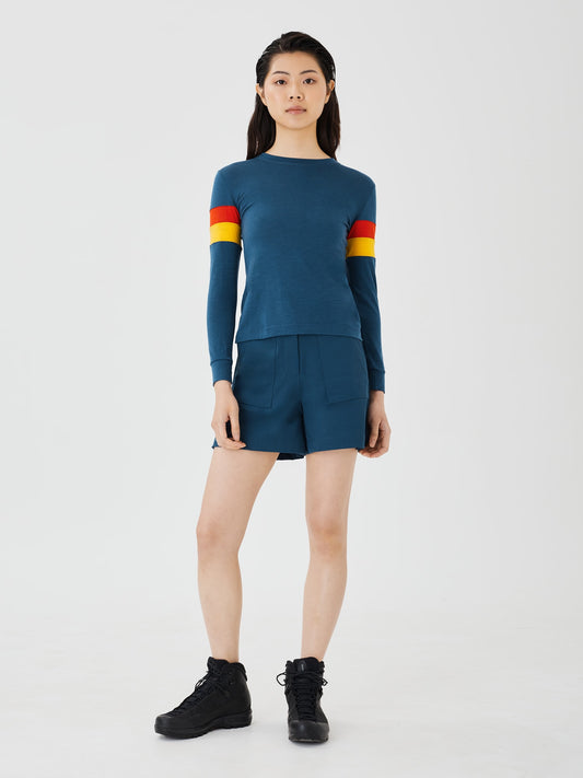 Front view of a women's blue merino wool long sleeve top by Šumska, tucked in, showcasing a comfortable and breathable design.