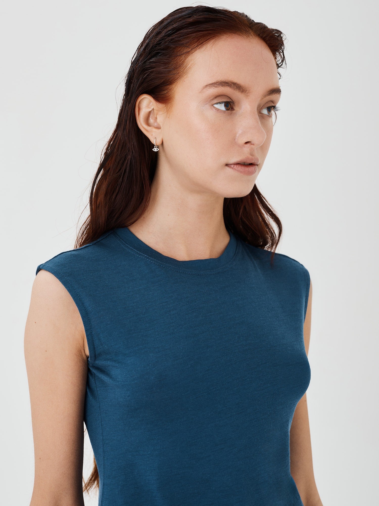 Zoomed-in view of a women's blue merino wool sleeveless T-shirt by Šumska, highlighting the fine fabric texture and stitching details.