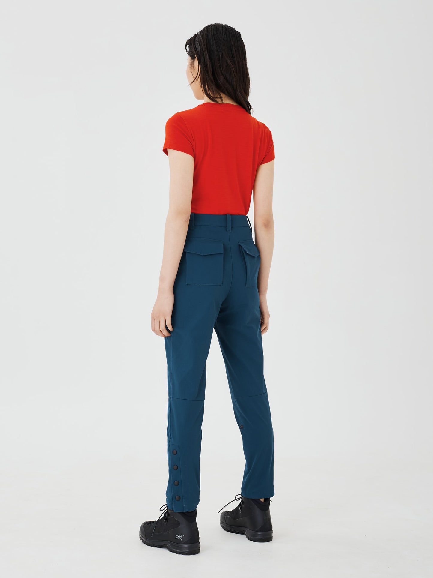 Full back view of blue Softshell Hiking Pants by Šumska, paired with a red classic merino T-shirt, highlighting the pants' comfortable fit and durable design.