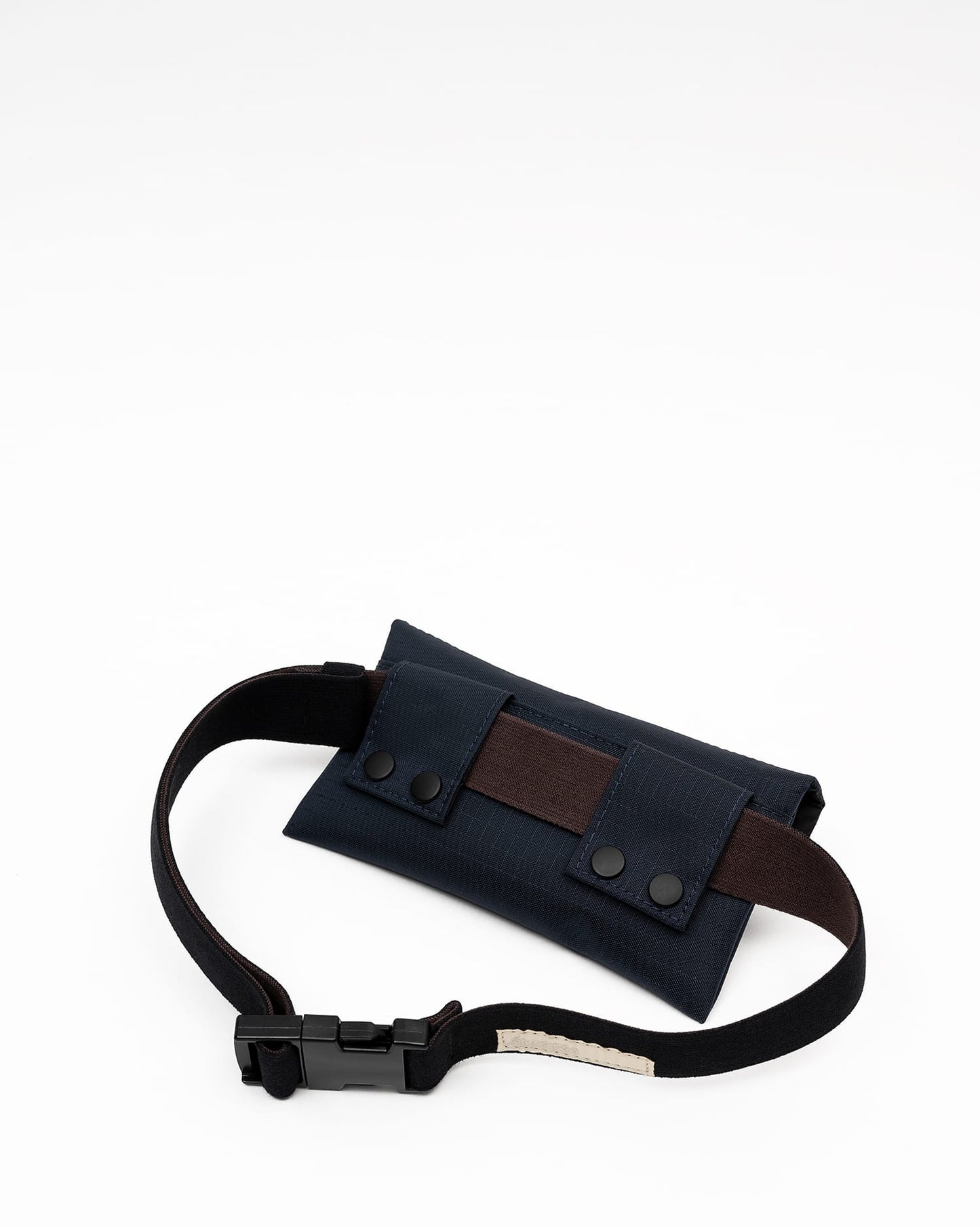 Back view of a midnight blue Cordura Belt Bag by Šumska, displaying snap-button attachment loops for secure fastening.