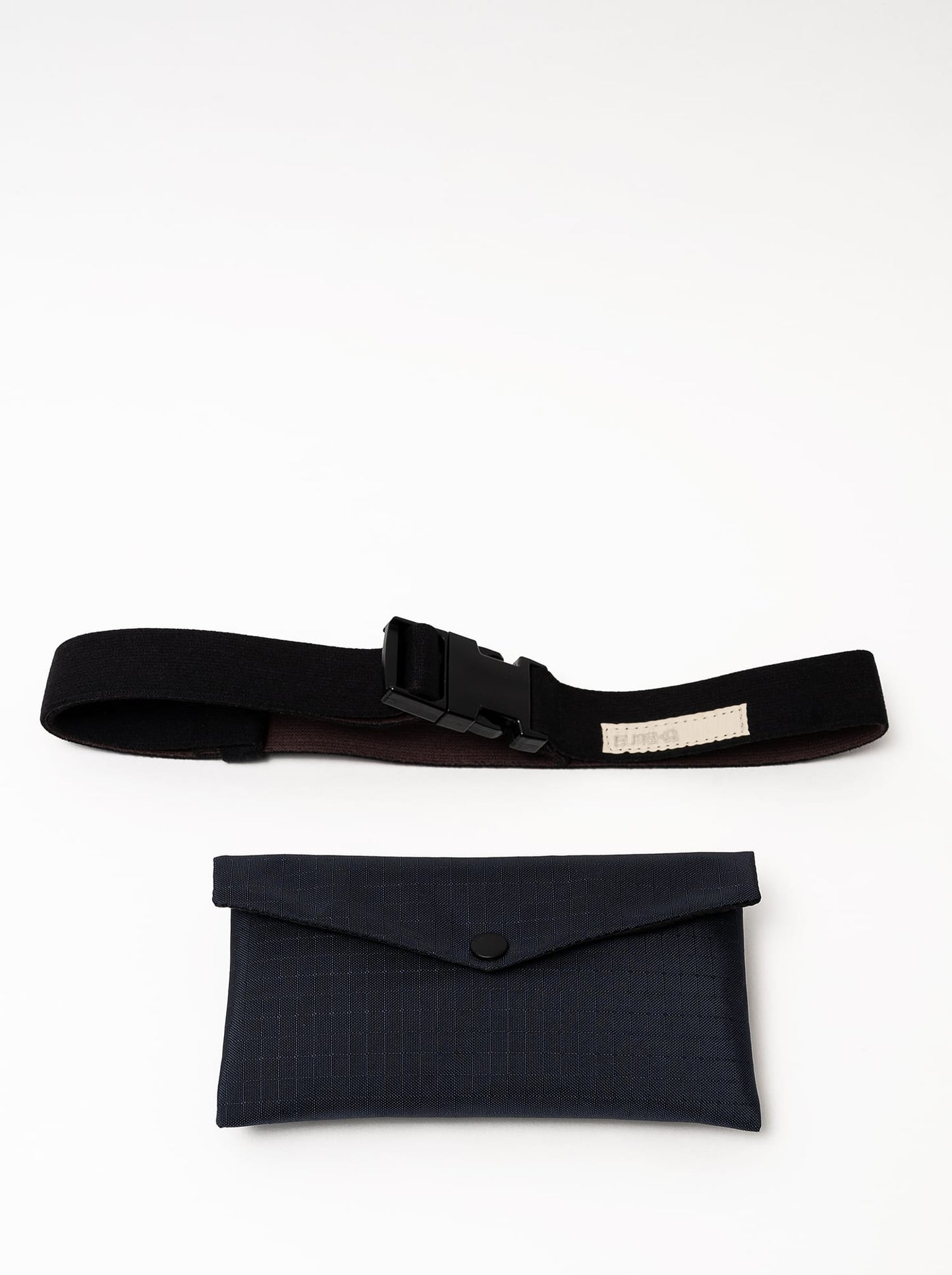 Front view of a midnight blue Cordura Belt Bag by Šumska, displaying the belt and envelope bag separately, highlighting the snap button attachment.