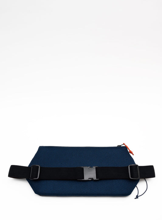 Back view of the Šumska midnight blue Cordura sling bag, featuring a soft 3D mesh backing, black elastic strap, buckle, and adjustable glider for comfort and secure fit.