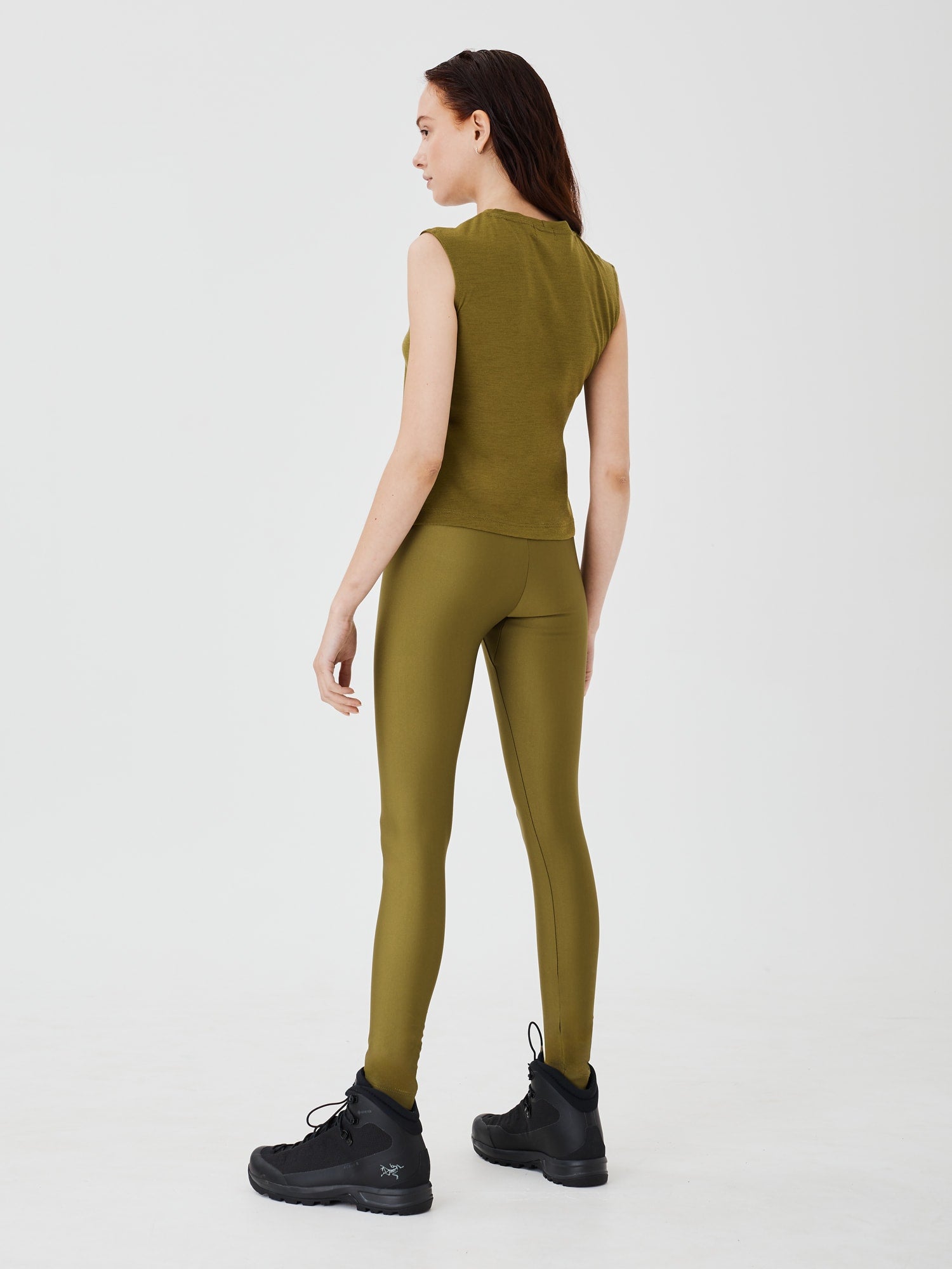 Back view of a women's olive green merino wool sleeveless T-shirt by Šumska, showcasing the smooth fit and breathable design.