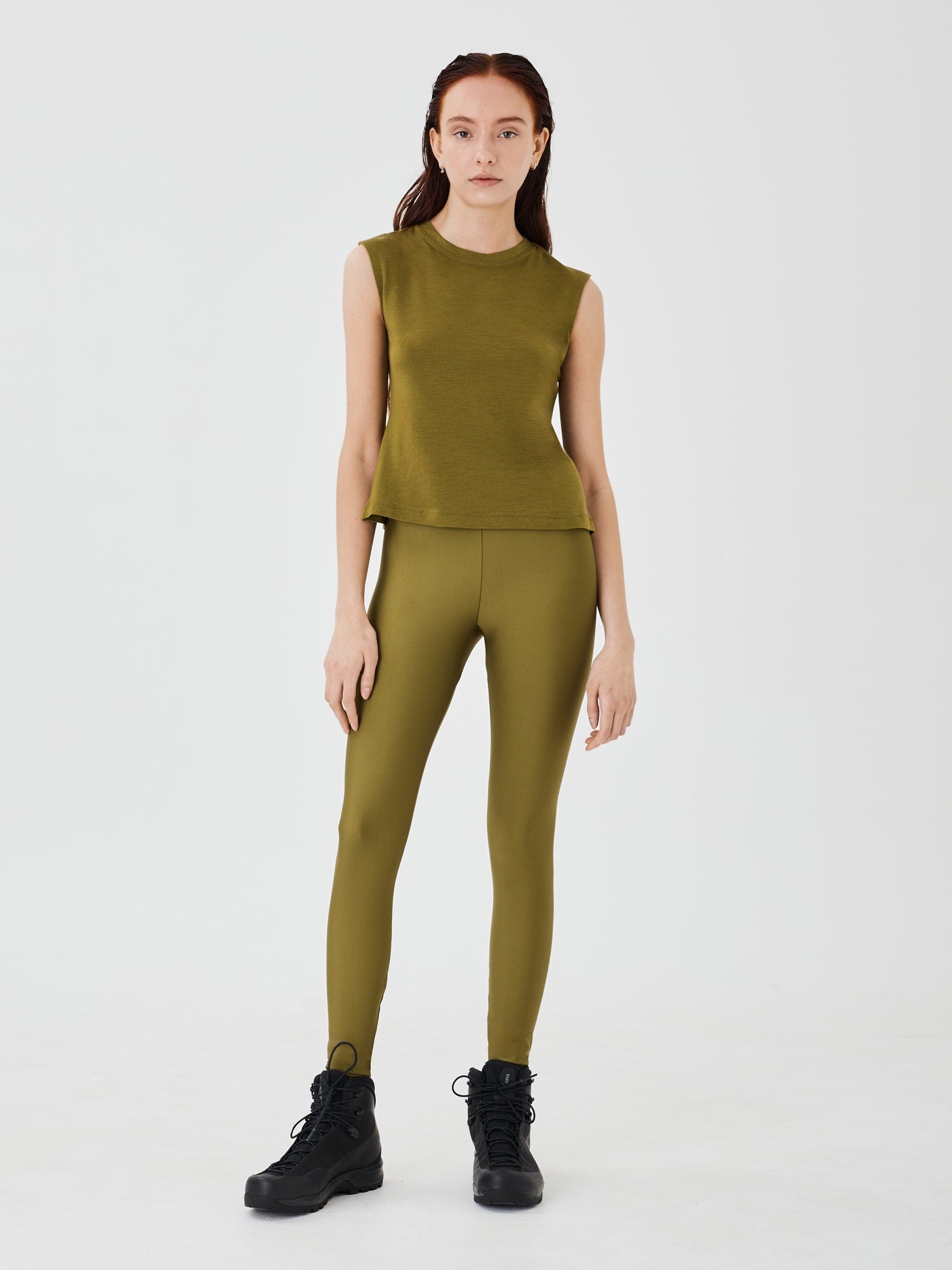 Front view of a women's olive green merino wool sleeveless T-shirt by Šumska, featuring a comfortable and lightweight design.