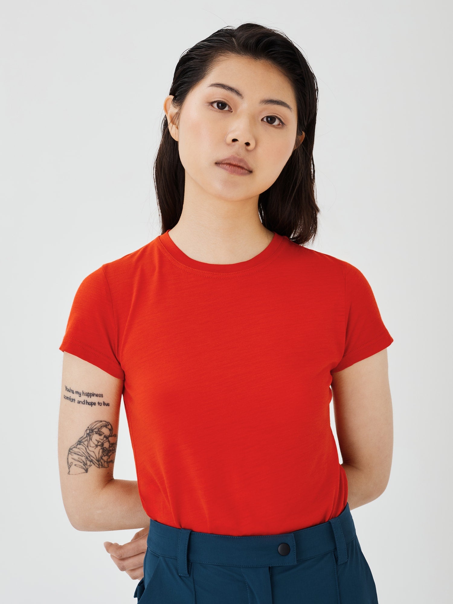 Close-up view of a women's red merino wool classic T-shirt by Šumska, showcasing the fabric texture and smooth finish.