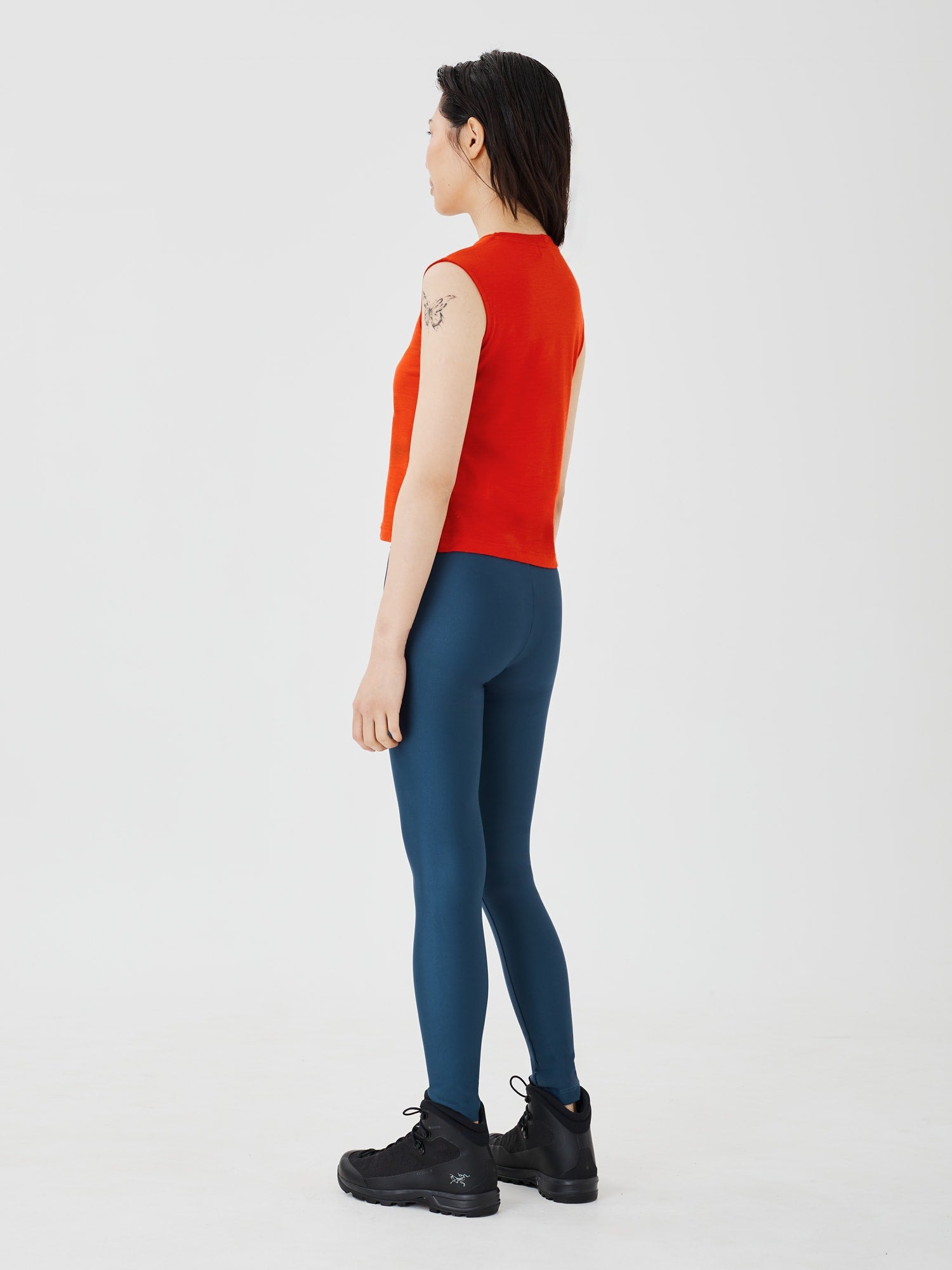 Back view of a women's red merino wool sleeveless T-shirt by Šumska, showcasing the smooth fit and breathable design.