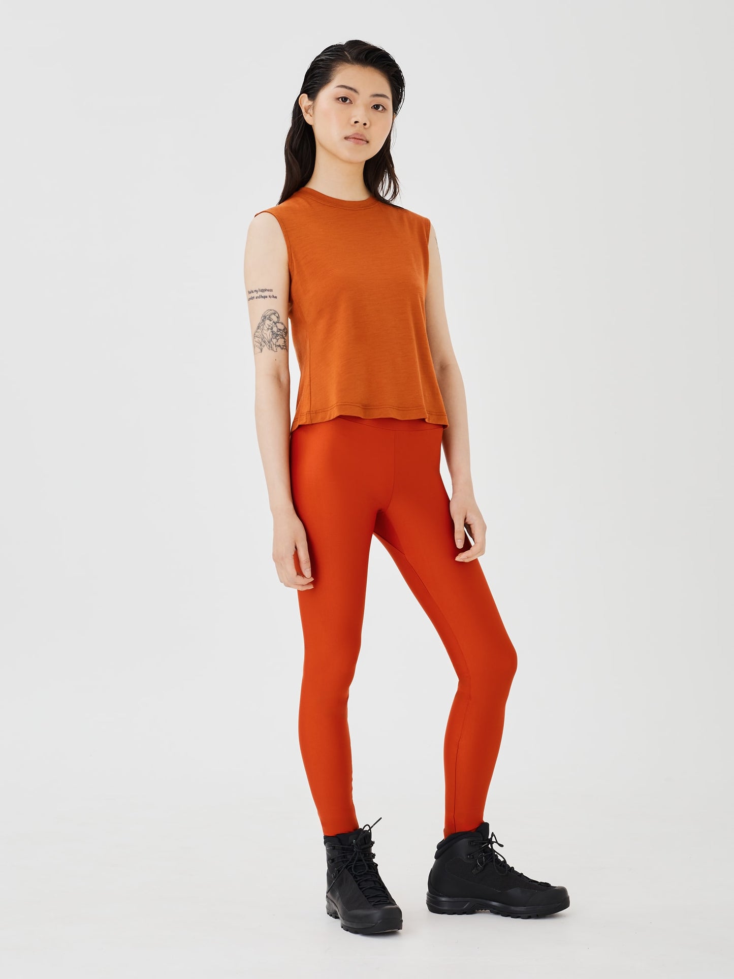 Front view of a women's rust merino wool sleeveless T-shirt by Šumska, featuring a comfortable and lightweight design.