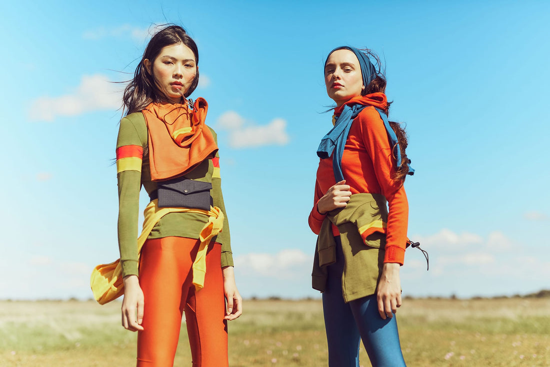 Two women wearing merino tops and bags with leggings 