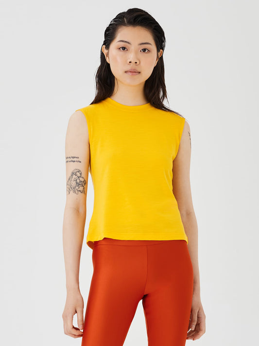 Close-up view of a women's yellow merino wool sleeveless T-shirt by Šumska, showcasing the fabric texture and sleeveless design.